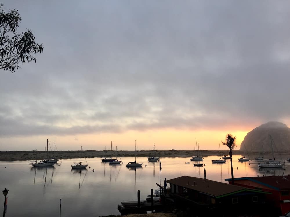 The sun sets behind Morro Rock, Morro Bay, California