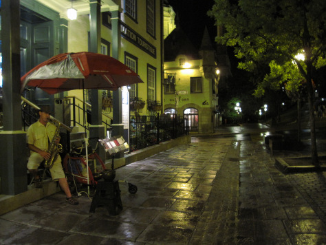 Street performer on a rainy night