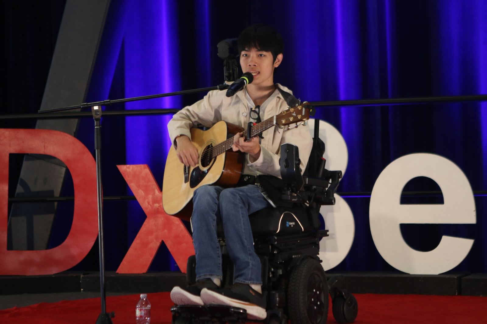 Musician performing with an acoustic guitar at TEDxBerkeley 2026