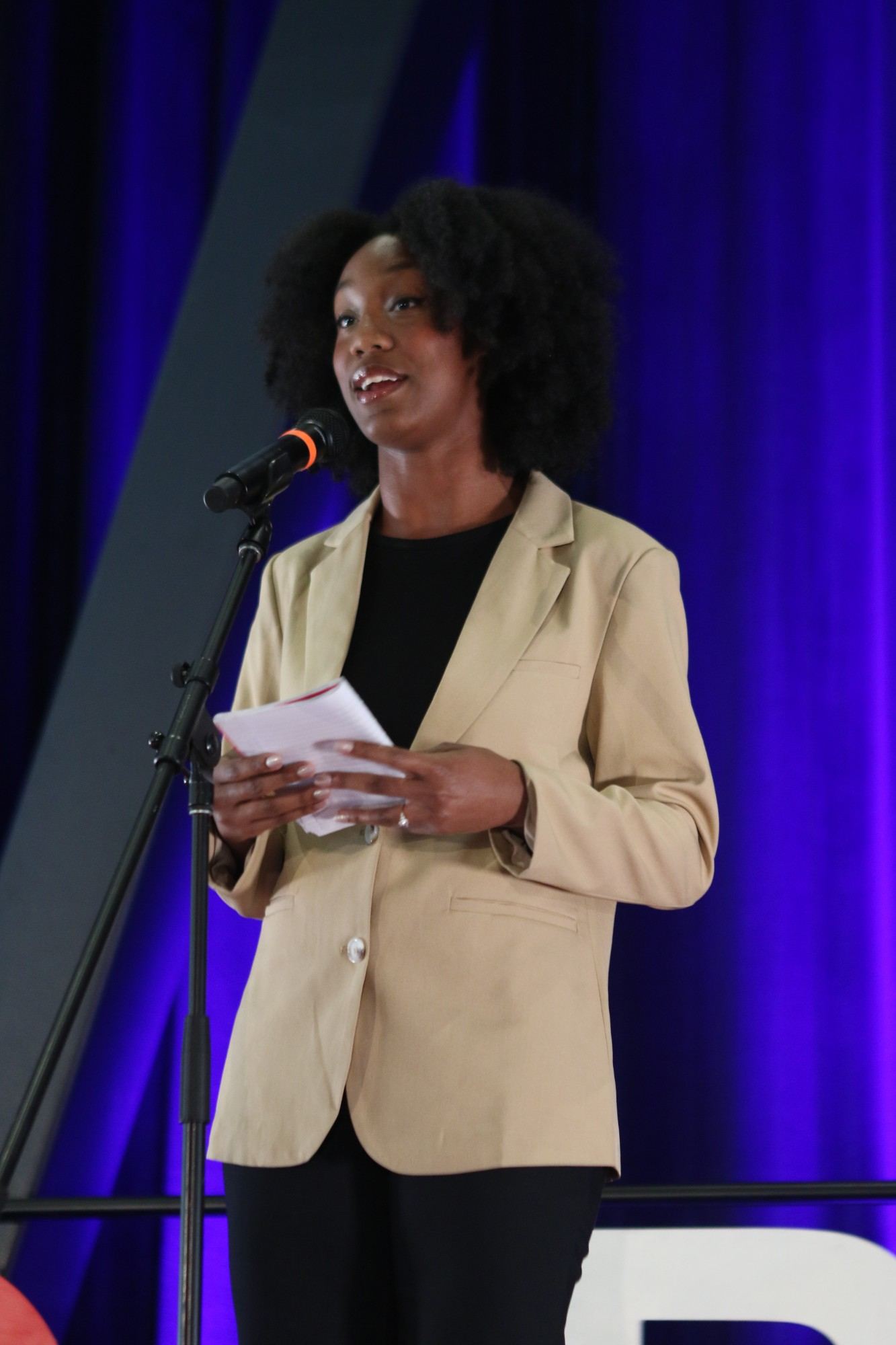 Milissa Sutton performing spoken word on stage at TEDxBerkeley 2026