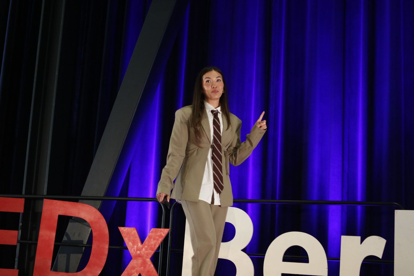 Taylor Krause making a point on stage at TEDxBerkeley 2026