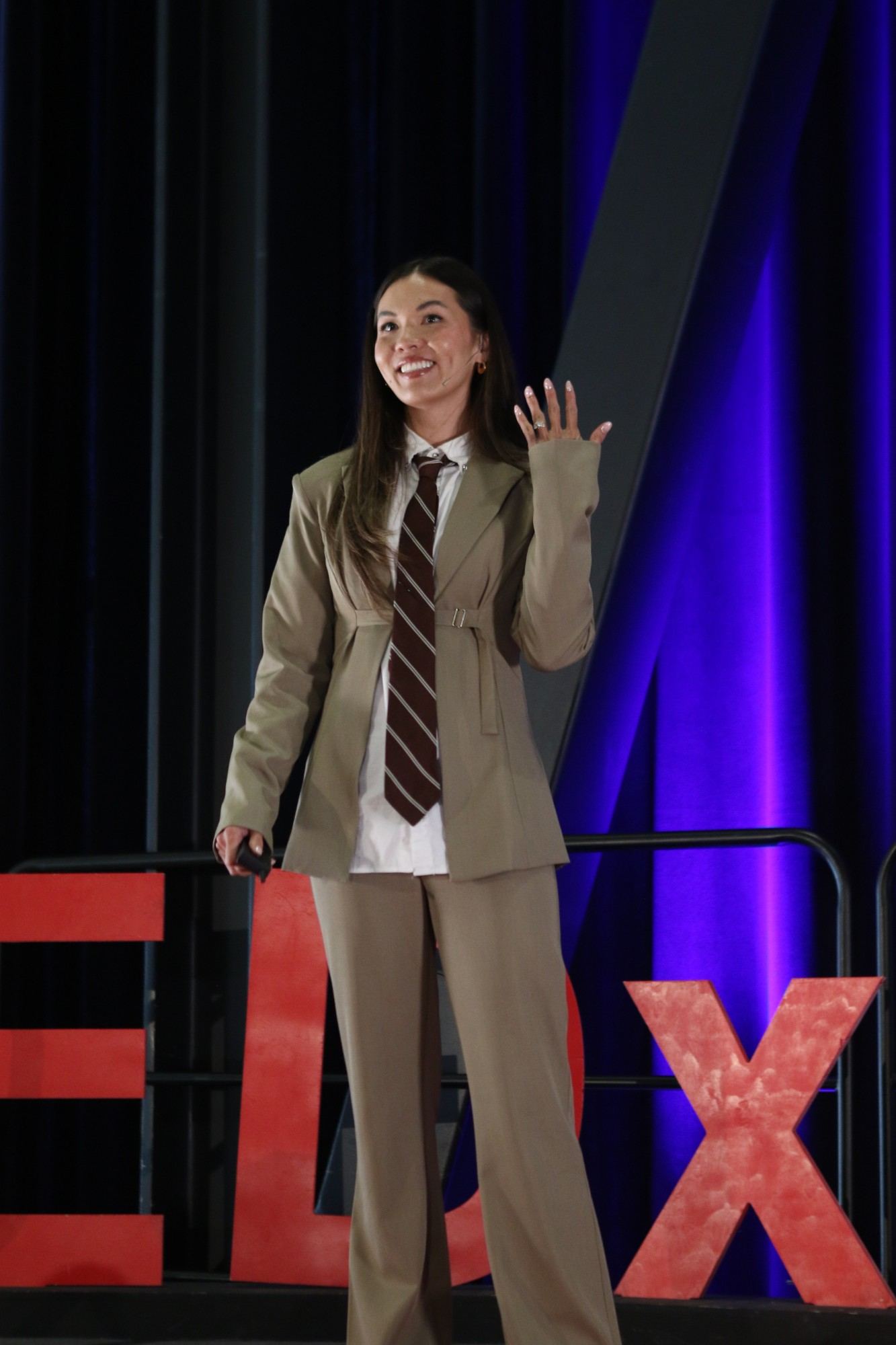 Taylor Krause waving to the TEDxBerkeley 2026 audience