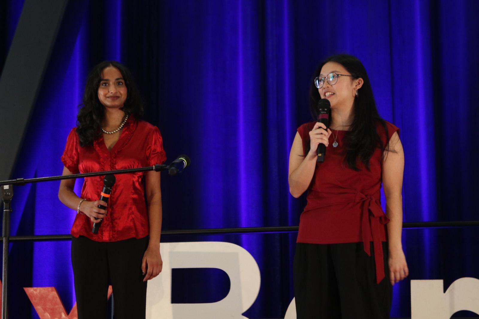 The two TEDxBerkeley 2026 hosts opening the event on stage